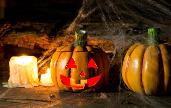 decoration for the hallowen celebration with pumpkins, spiders, candles on rustic wood