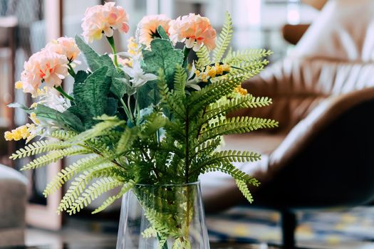 Pink Flower vase on table decoration in living room.