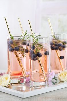 Cold shot in glass with blueberry, ice cubes, rosemary. Celebratory inspiration in Provence style