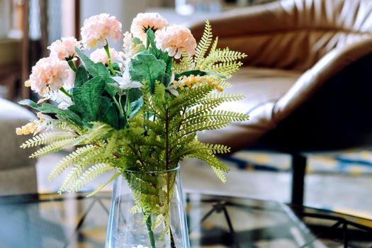 Pink Flower vase on table decoration in living room.