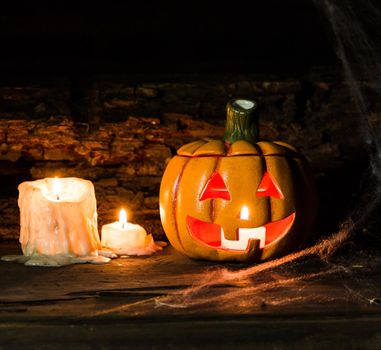 decoration for the hallowen celebration with pumpkins, spiders, candles on rustic wood
