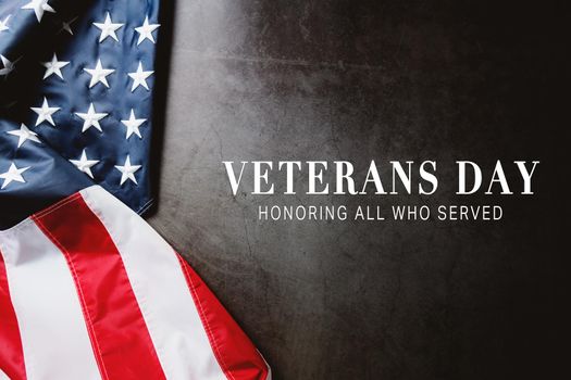 Veterans day. Honoring all who served. American flag on gray background with copy space.