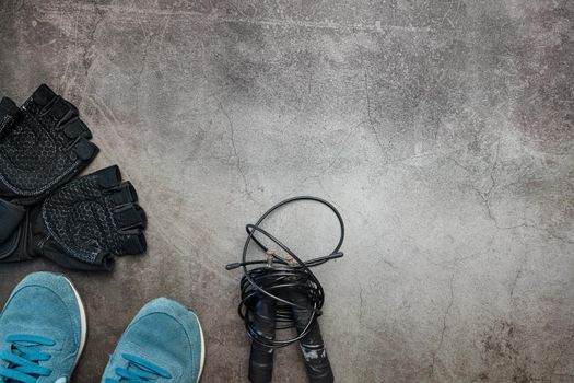 Healthy lifestyle. Jump rope  equipment on a grey background. Top view with copy space.