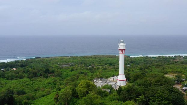 Cape Bolinao Lighthouse. Beautiful landscape, lighthouse on the island of Luzon. Summer and travel vacation concept. Ocean coast with rainforest. Luzon Island, Philippines.