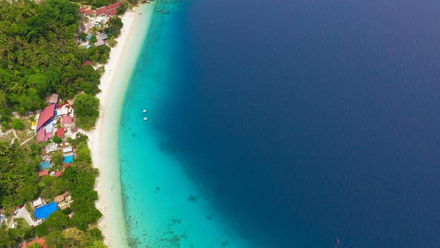 Aerial view of sandy beach on a tropical island with palm trees. Canibad beach, Philippines,Samal island.