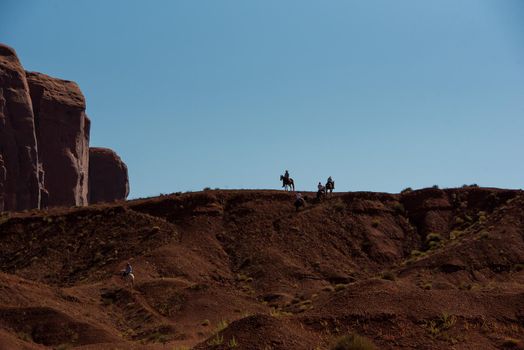 Silhouette of horse riders on Navajo land in Monument Valley Utah