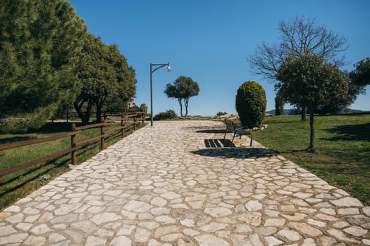 Beautiful stone pavement in mountain village with neat lawn and trees. Sunny day with clear sky in Tavertet, Catalonia, Spain