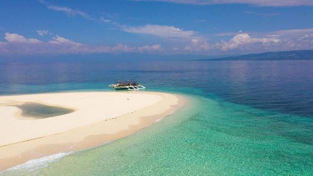 Tranquil beach scenery. Exotic tropical beach landscape with white sand beach and amazing turquoise sea. Digyo Island, Philippines.