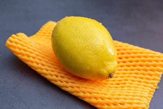 A variety of very sour, ripe and juicy lemon close-up, lying on a soft package