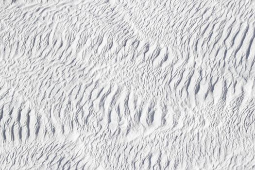 White texture of Pamukkale calcium travertine in Turkey, abstract pattern of the feathers close-up.