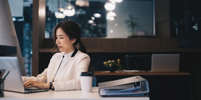 Photo of gorgeous secretary working at office. she sitting at the wooden desk.