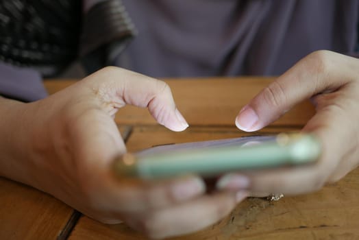 close up of women hand holding smart phone.