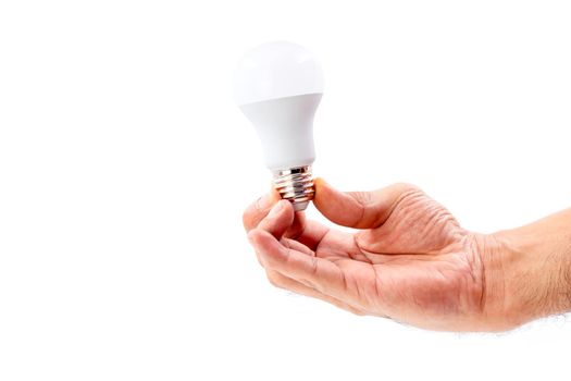 Human hand holding LED light bulb isolated on white background.