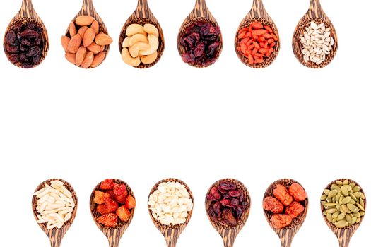 Top view group of whole grains and dried fruits 12 kinds on wooden spoons with copy space isolated on white background.