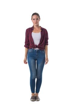 Casual blonde woman standing in jeans and checked shirt against a white background
