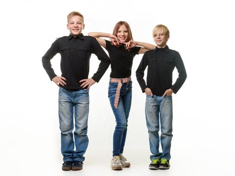 Happy children on a white background, two boys and a girl in casual clothes