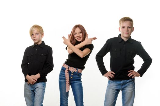 Happy children on a white background, a girl directed improvised pistols from her hands to the side of her brothers