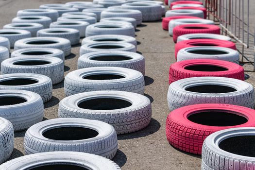 Tires lying on the track of the race track for safety in case of accidents