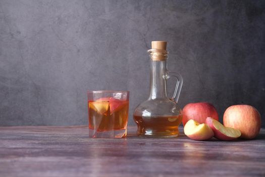 apple vinegar in glass bottle with fresh green apple on table ,