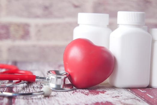 heart shape symbol and stethoscope on table ,