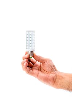 Human hand holding LED light bulb isolated on white background.