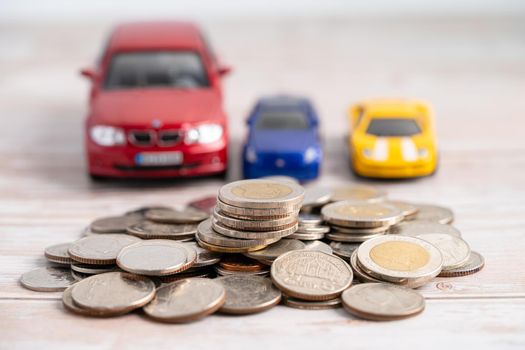 Car on coins background; Car loan, Finance, saving money, insurance and leasing time concepts.