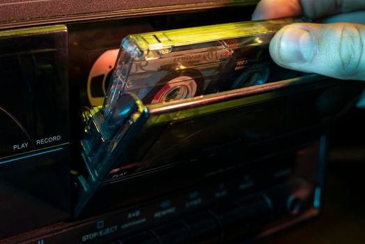 Insert the music cassette into the old cassette player