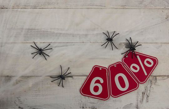 sixty percent discount on Halloween background-price tag on rustic old white wooden background