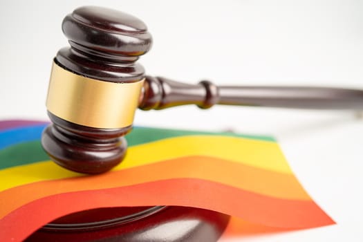 Gavel for judge lawyer on rainbow flag, symbol of LGBT pride month celebrate annual in June social of gay, lesbian, bisexual, transgender, human rights.