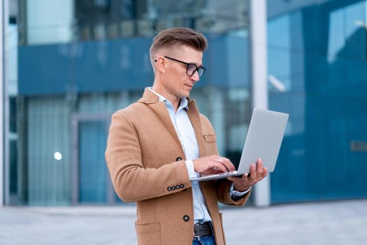 Business. Businessman Using Laptop Outdoor Adult Caucasian Male Business Person Eyeglasses Watching Notebook Screen Outside Serious Thinking Sanlight Background Big City Street