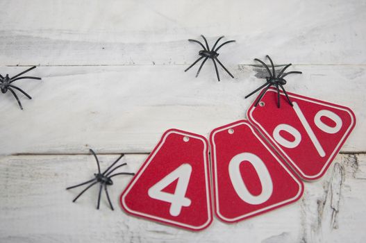 forty percent discount on the Halloween background-price tag on a rustic old white wooden background