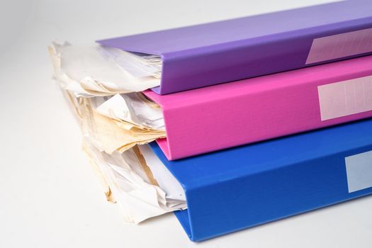 File Folder Binder stack of multi color on table in office.