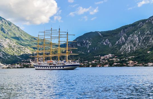 Kotor, Montenegro, July 18, 2021: Pirate ship at sea in the Bay of Kotor. In the background there is a mountain range. Travel along the coast of Montenegro.