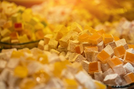 Eastern traditional sweets, a huge variety of types of Turkish delight: lokum with pistachios, cocoa, saffron, nuts, roses and much more. Grand Bazaar in Istanbul, Turkey.