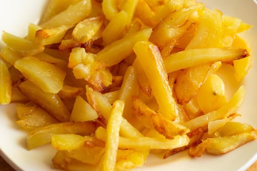 a plate of mouth-watering fresh fried potatoes with a golden crust.