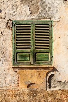 Broken and damaged window in an old house in Spain
