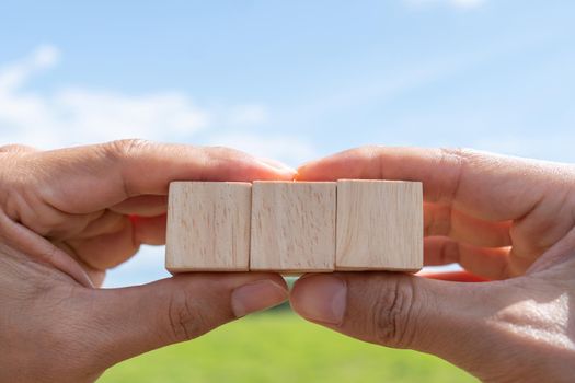 Blank wooden cube that you can put text or icon on in hand hold background