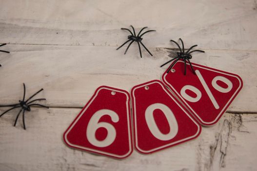 sixty percent discount on Halloween background-price tag on rustic old white wooden background