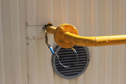 Yellow gas pipe connector system close up outdoor