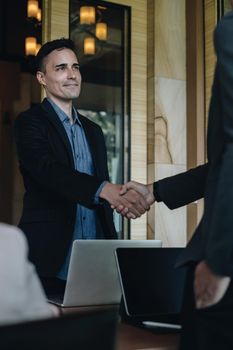 Businessman and partner handshake for the new agreement after sign in agreement contract with work together
