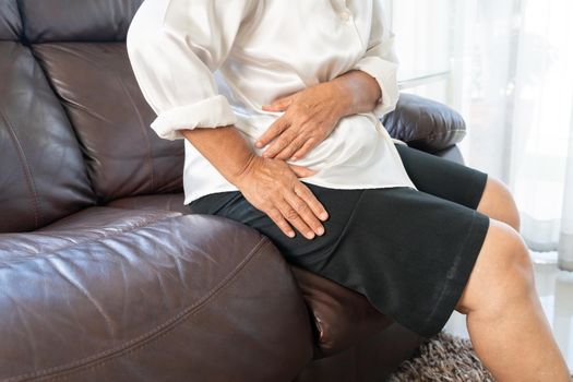 Hip pain of senior woman at home, healthcare problem of senior concept