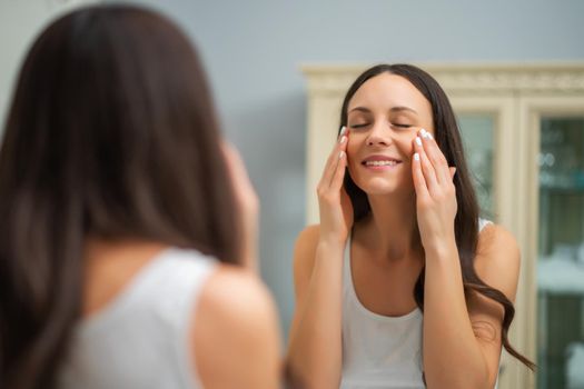 Beautiful woman enjoying her skin after successful skin treatment.