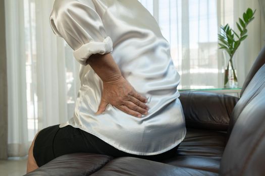 Old woman back pain at home, health problem concept