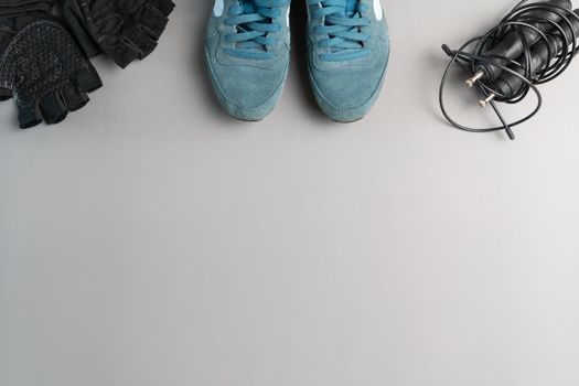 Healthy lifestyle. Jump rope  equipment on a grey background. Top view with copy space.