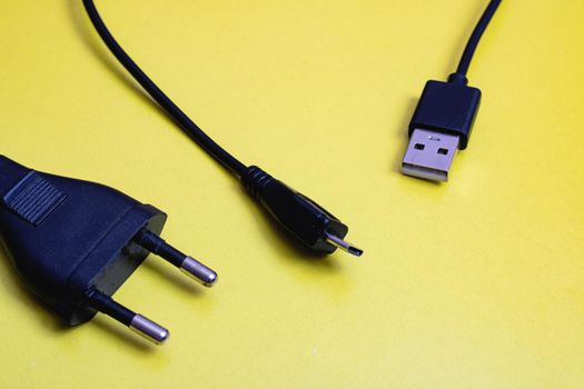 Plug and usb on yellow background close up