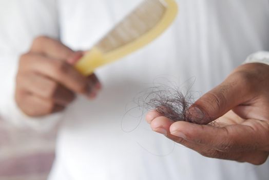 man hold his list hair close up ,