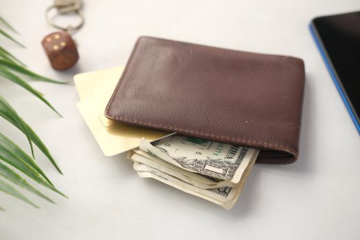 close up of wallet, cash and credit card on table .