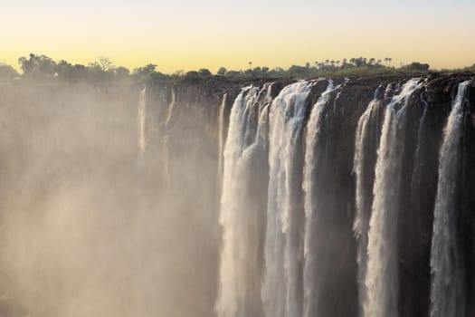 Victoria Falls on the Zambezi River between Zimbabwe and Zambia, at sunset