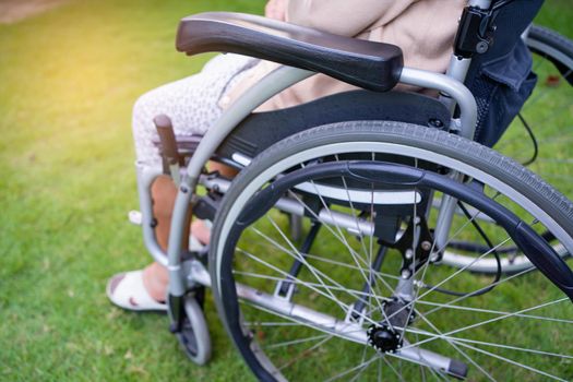 Asian senior or elderly old lady woman patient on wheelchair in park, healthy strong medical concept.