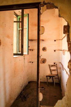 Abandoned house with broken furniture in the gold mines of Rodalquilar village in Almeria province, Spain.